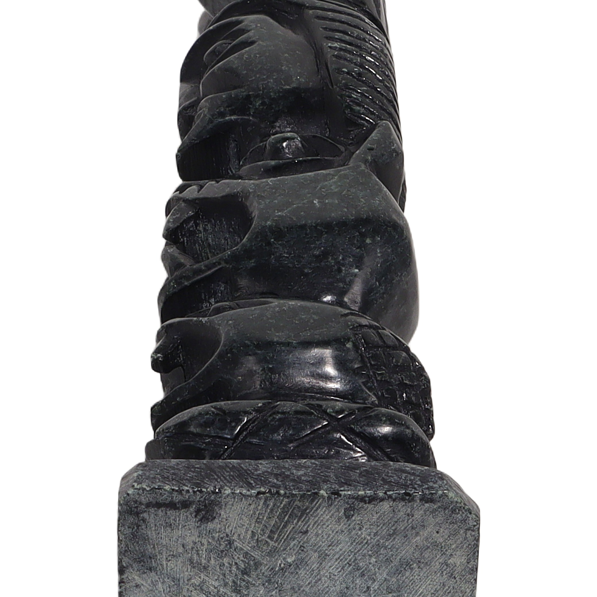 Stone totem pole sculpture base close up, vintage carved stone art detailed bottom section