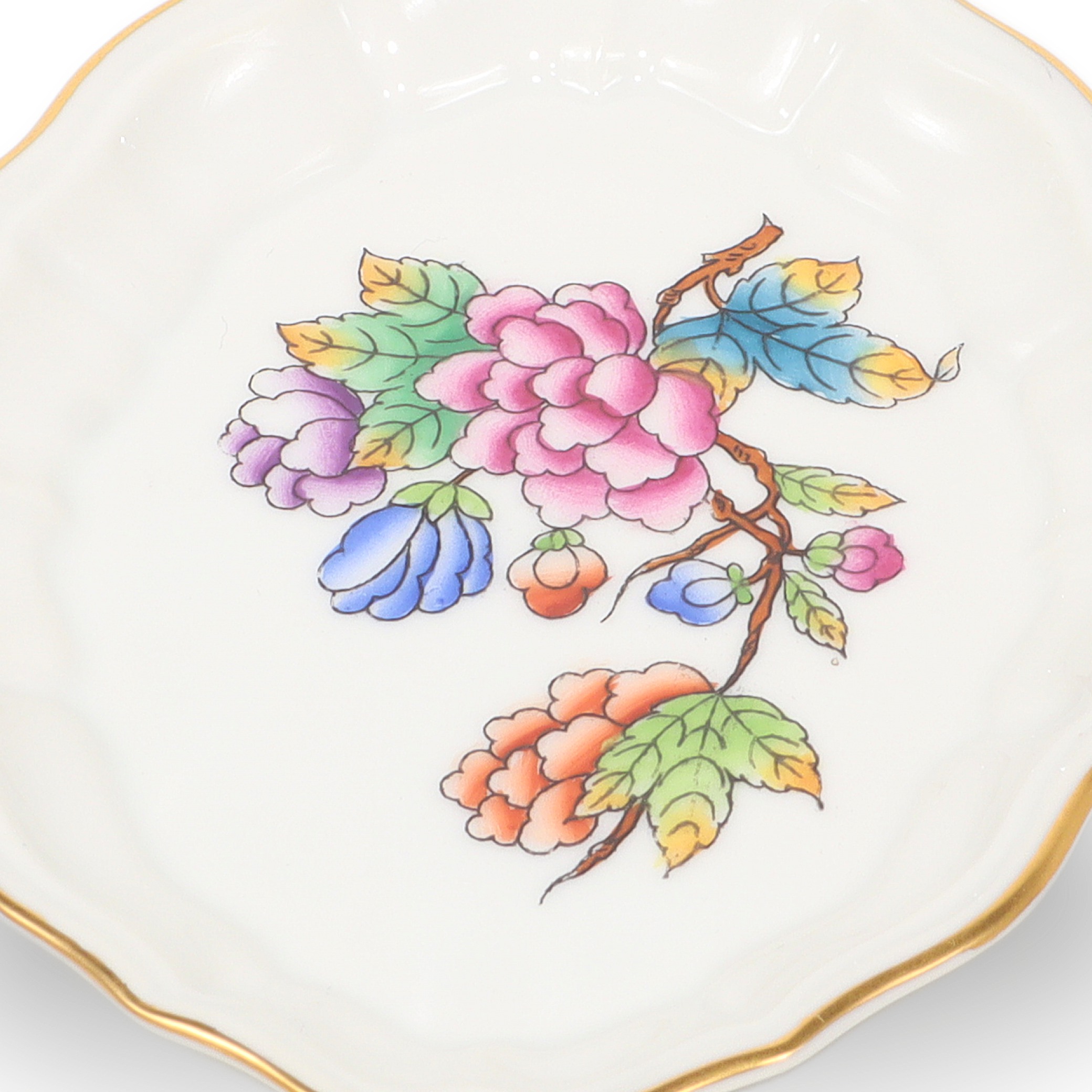 Luxury jewelry tray close up, porcelain tray with colorful floral pattern and gold rim