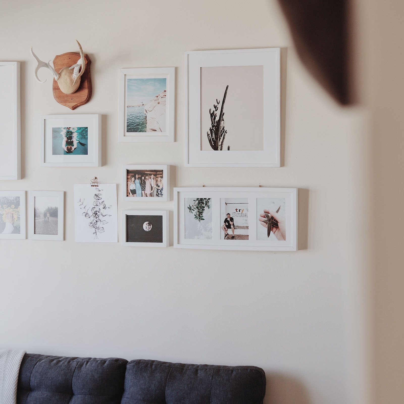 Gallery wall of photos framed at many different sizes