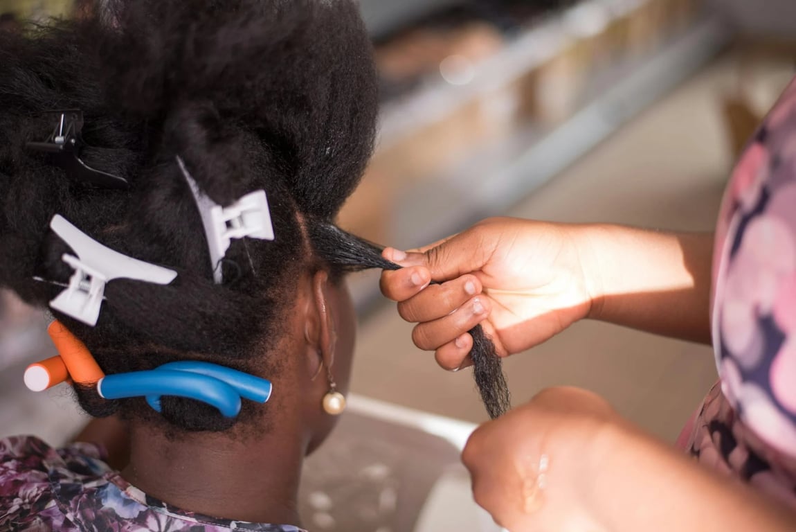 Child getting synthetic braids installed