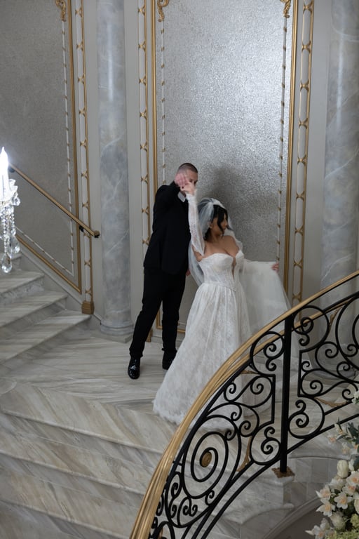Couple twirling on grand staircase
