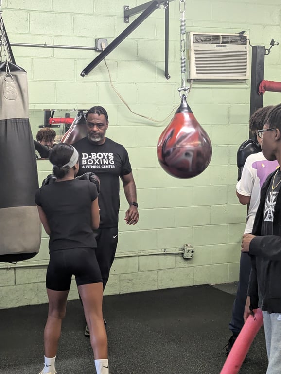 Coach Price teaching a student at D-Boys Boxing