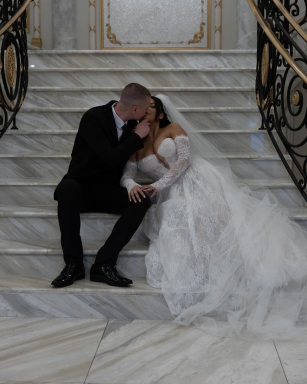 Dooners kissing on marble stairs
