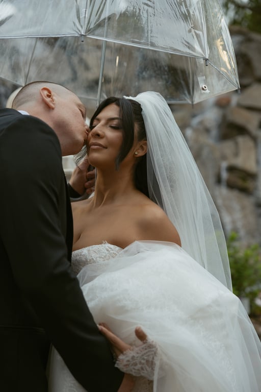 Couple kissing under umbrella