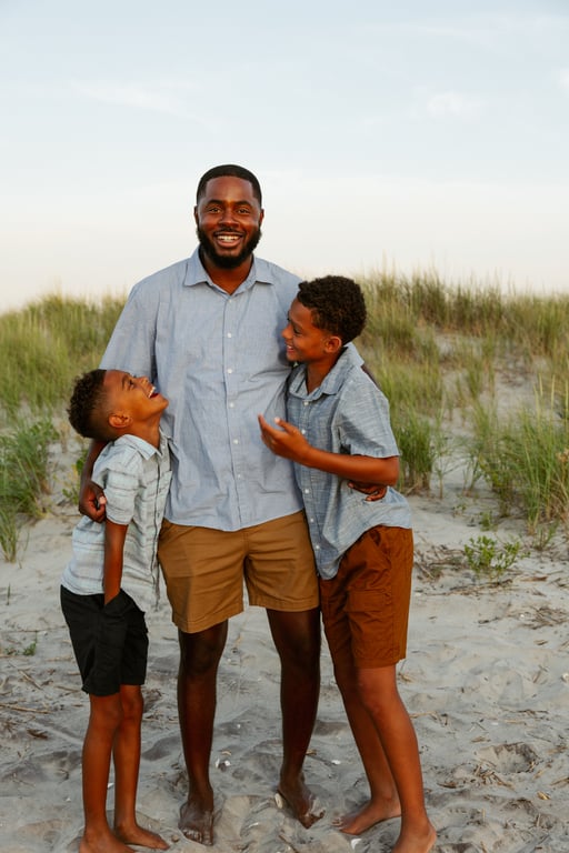 Father with young sons on the beach