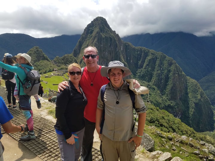 Family posing for photo while on vacation in the rain forest.