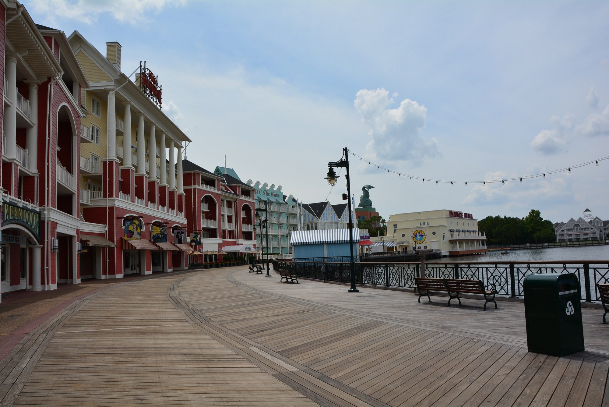 Stringed lights and brightly colored buildings line the boardwalk at Disney's Boardwalk Villas
