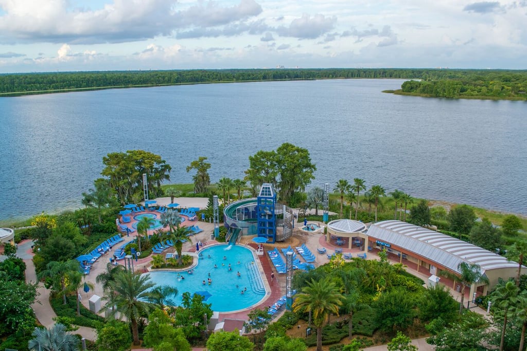 A waterslide feeds into the pool at Bay Lake Tower, surrounded by a lake