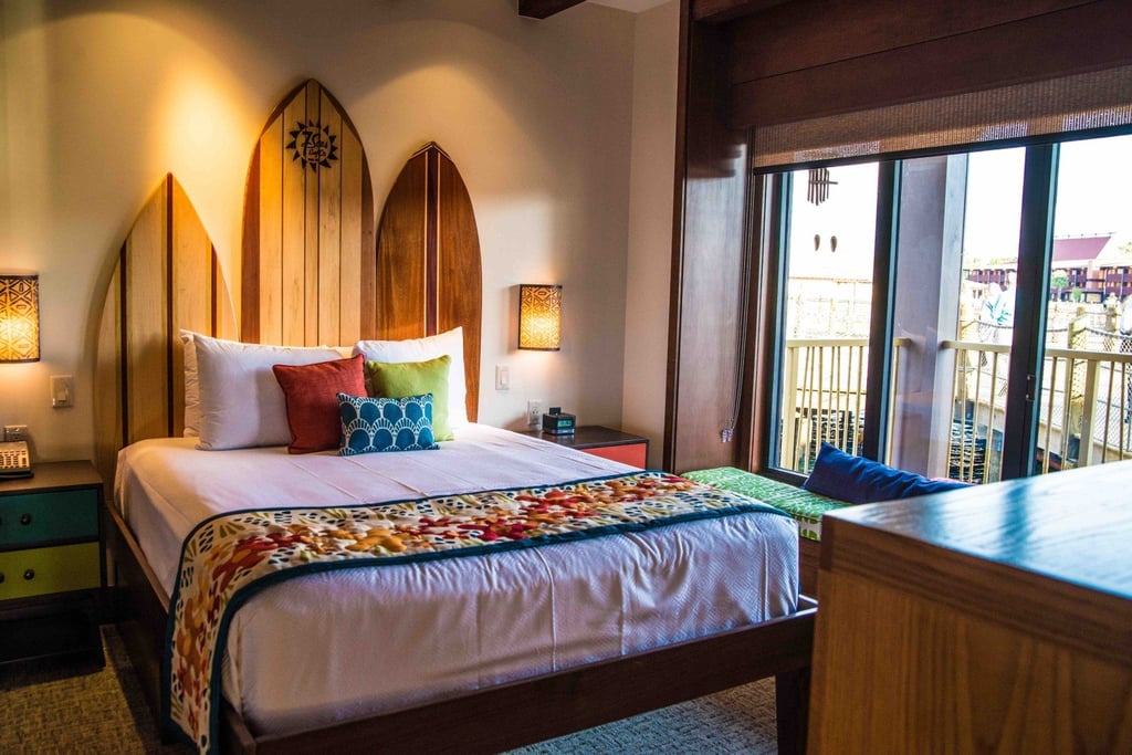 Surfboards act as a headboard in a bungalow guest room