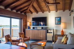 A large flatscreen TV is the focal point of an earth-toned living room