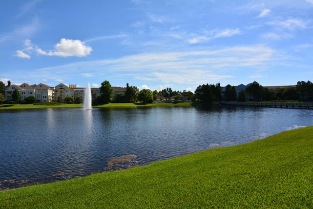 Disney's Saratoga Springs from across a lake with a fountain