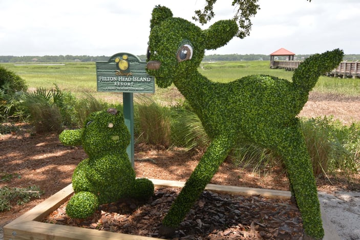 Bambi and Thumper topiary statues with a Disney's Hilton Head Island Resort sign.
