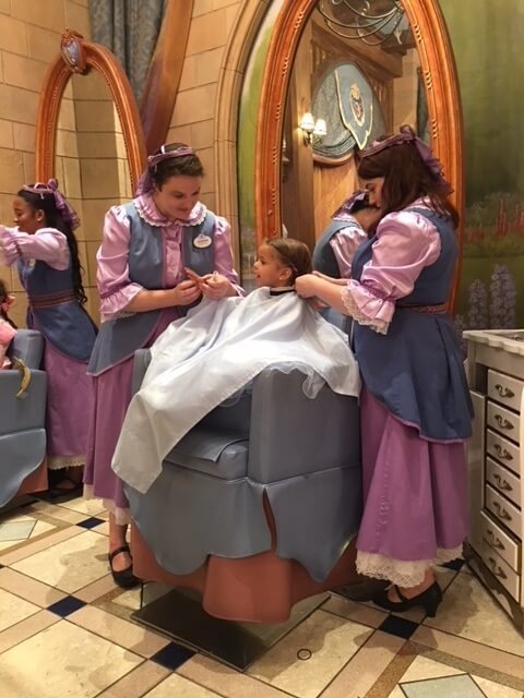 Cast members helping a guest at Bibbidi Bobbidi Boutique at Disney World