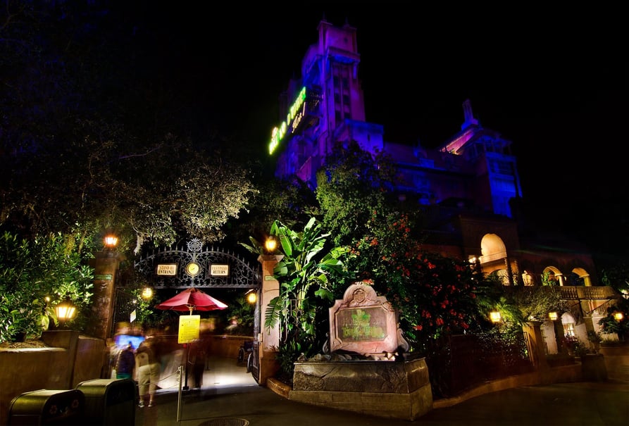 Tower of Terror at night lit in blue and purple light
