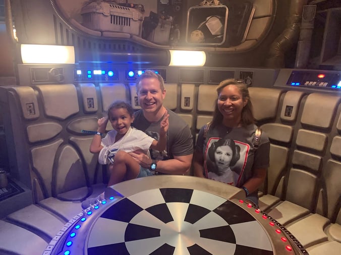 Family sitting at the game table in the Millenium Falcon