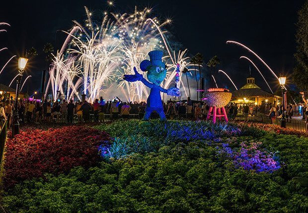 Epcot's Food and Wine Festival Fireworks behind a blue topiary Mickey Mouse