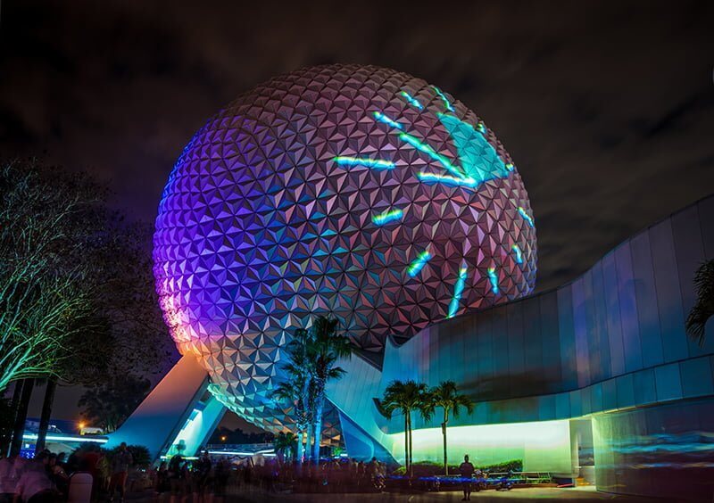 EPCOT Spaceship Earth pictured with clock projected onto exterior at night