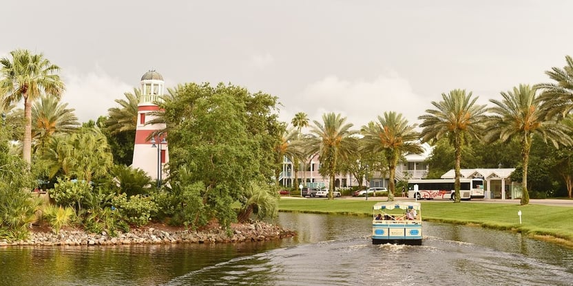 Old Key West waterway with a boat and lighthouse