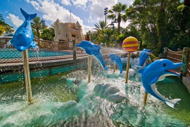 Water, bridge, sandcastle, and dolphins outside of Olivias Cafe at DVC Old Key West