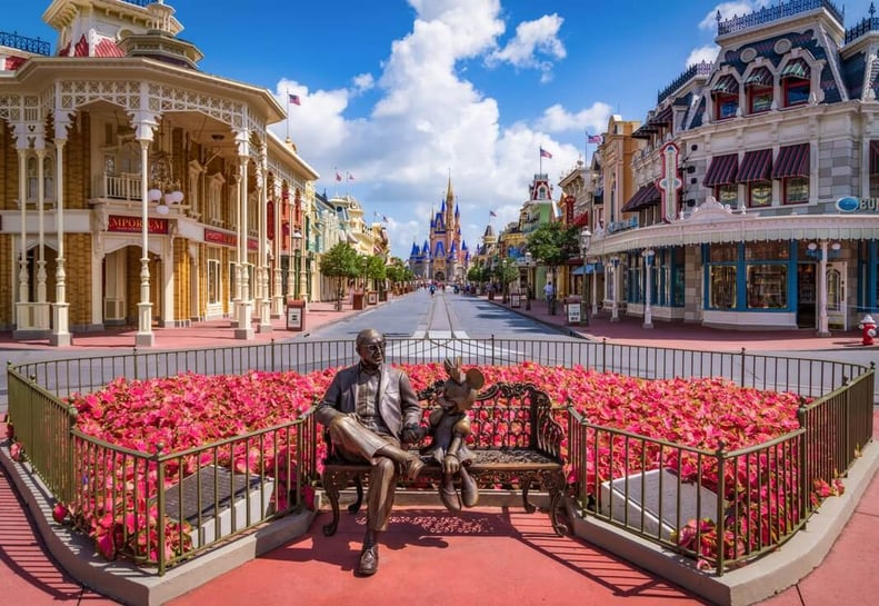 Sharing the Magic bench statue of Roy O. Disney and Minnie Mouse at Magic Kingdom