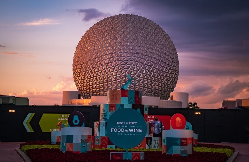 EPCOT pictured with Food and Wine festival sign at sunset