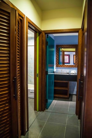 Bright green walls illuminate the hallway of a studio