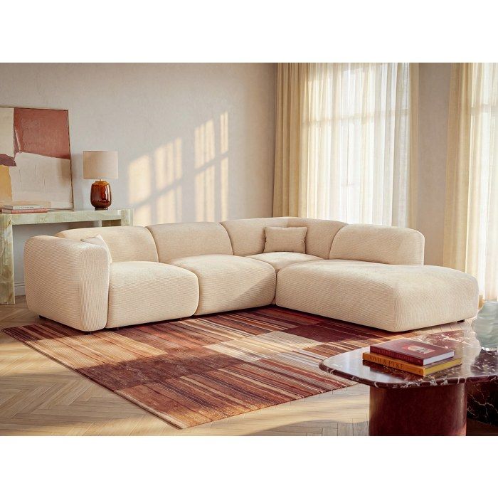 Produit similaire: Grand canapé d'angle droit avec dossier méridienne en tissu texturé beige POGNI de Maison Céphy