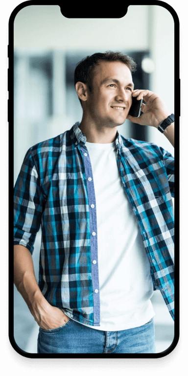 A man making a phonecall while smiling.