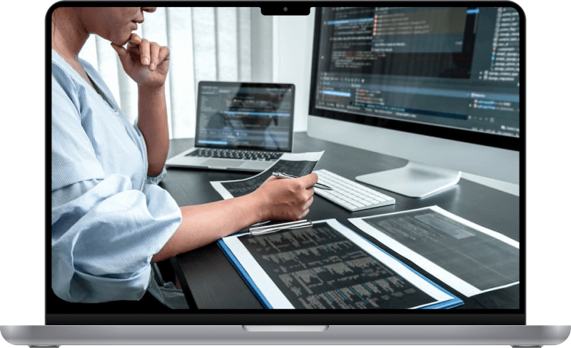 A woman analyzing some statistics at her computer.