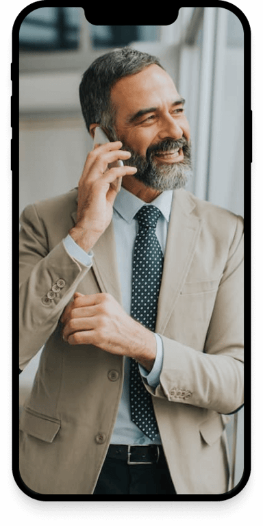 A business smiling while making a phonecall.