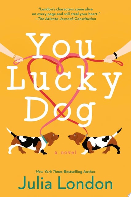 The cover showcases two basset hounds at the bottom, connected by leashes that form a heart above the title. A bright yellow background enhances the cheerful theme.