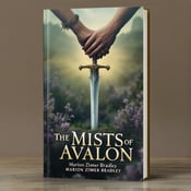 standing book mockup, Its title is "The Mists of Avalon". Its author name is Marion Zimmer Bradley.  The cover features a central focus on a sword embedded in the ground, with heather fields enveloping the background. Clasped hands are positioned above the book title, representing the themes of love and betrayal. The book title, "The Mists of Avalon," is displayed in an elegant yet bold serif font, complementing the epic fantasy genre. The author name, Marion Zimmer Bradley, is presented in a smaller, more delicate font beneath the title., The sword is placed vertically, with the hilt at the bottom and the blade piercing through the center of the cover. The clasped hands hover above the title, positioned slightly to the left, creating a sense of connection and anticipation.