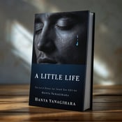 standing book mockup, Its title is "A Little Life". Its author name is Hanya Yanagihara.  The cover features a half-lit face of a man, with one tear visible on his cheek. The lighting creates a sense of sadness and tension, while also hinting at a glimmer of hope. The title is displayed in bold, capital letters across the lower half of the cover, with a dark blue color that complements the overall mood. The author's name is shown in a smaller, elegant font at the bottom of the cover., The half-lit face is centered on the cover, with the tear strategically placed to draw attention. The title and author's name are positioned at the bottom, ensuring they are easily readable without distracting from the main image.