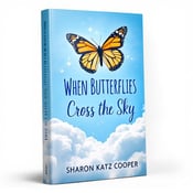 standing book mockup, Its title is "When Butterflies Cross the Sky". Its author name is Sharon Katz Cooper.  The cover features a close-up image of a vibrant Monarch butterfly in mid-flight, with its wings spread wide. The butterfly is centered on a sky blue background, with fluffy white clouds below, creating a sense of height and openness. The book title, "When Butterflies Cross the Sky," is written in a playful yet legible font, in a shade of deep blue that complements the sky blue background. The author's name, Sharon Katz Cooper, is written in a smaller, elegant font below the title., The title and author's name are placed at the bottom of the cover, allowing the butterfly to take center stage. The text is aligned to the left, creating a balanced composition.