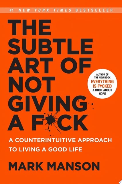 The cover features a bold, sans-serif title in black against a vivid orange background, with a subtle ink splatter adding a dynamic touch.