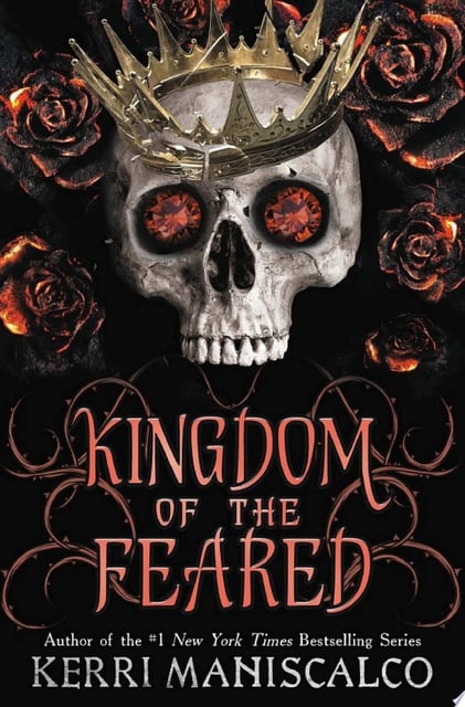 The original cover features a skull with a crown, framed by roses, against a dark background. The skull's eyes are replaced with fiery gemstones, providing a striking contrast to the muted tones.