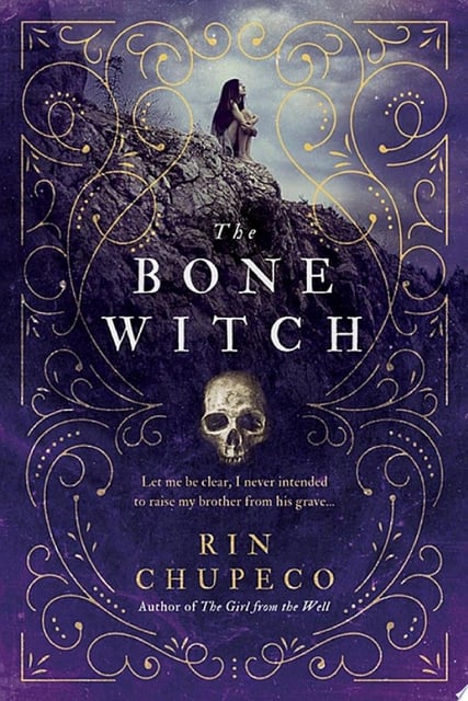 The cover features an intricate design with a central skull element surrounded by swirling patterns, creating a sense of mysticism and depth.
