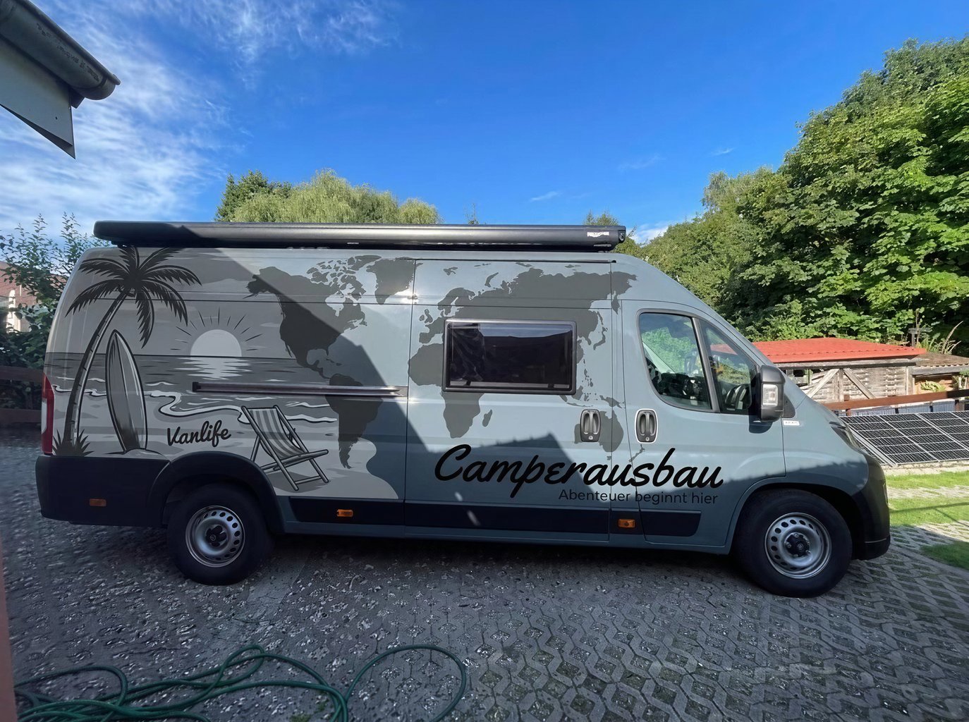 Camper van wrap with gray beach and world map design