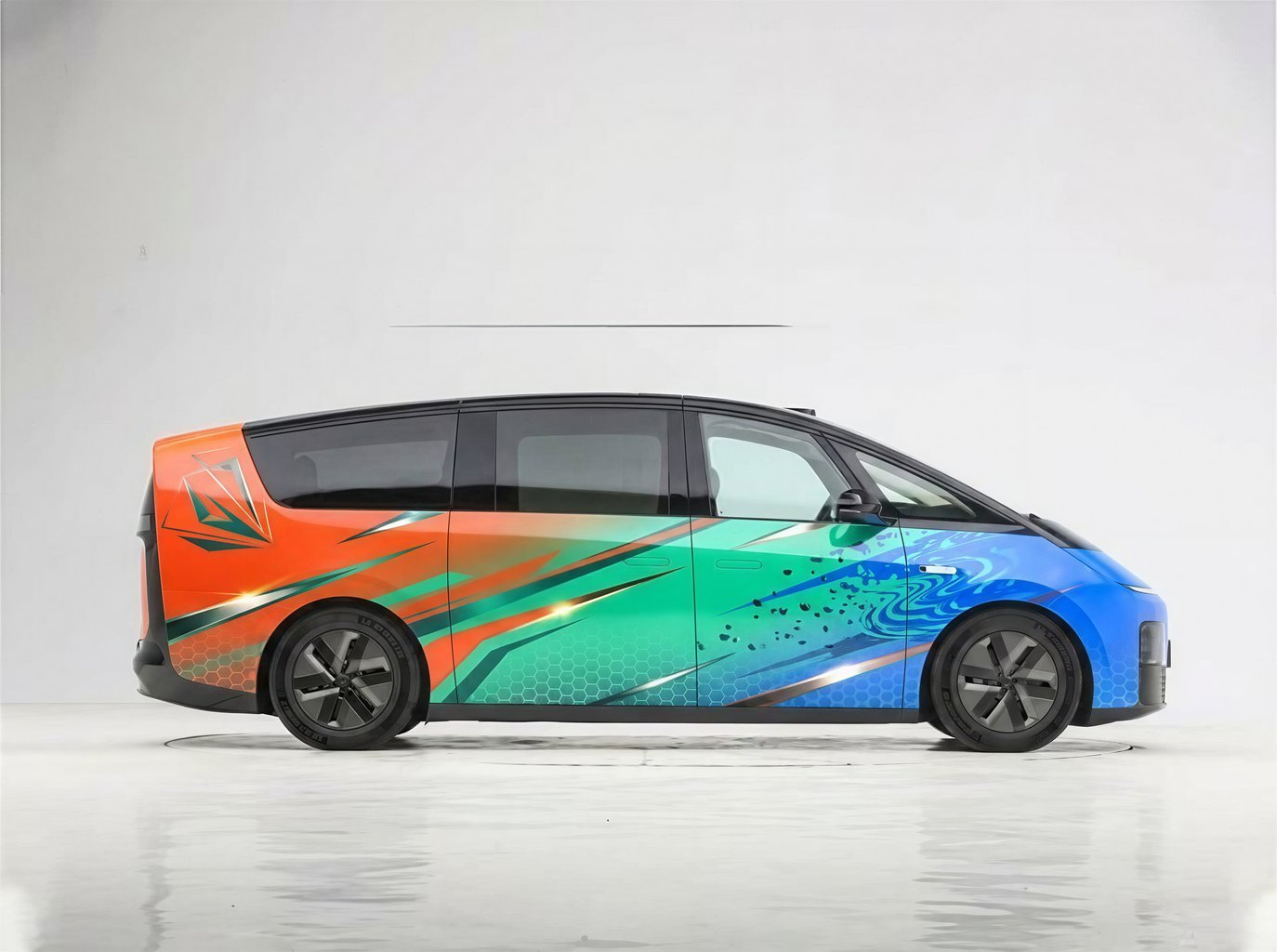 vibrant minivan wrap with abstract orange, green, and blue design