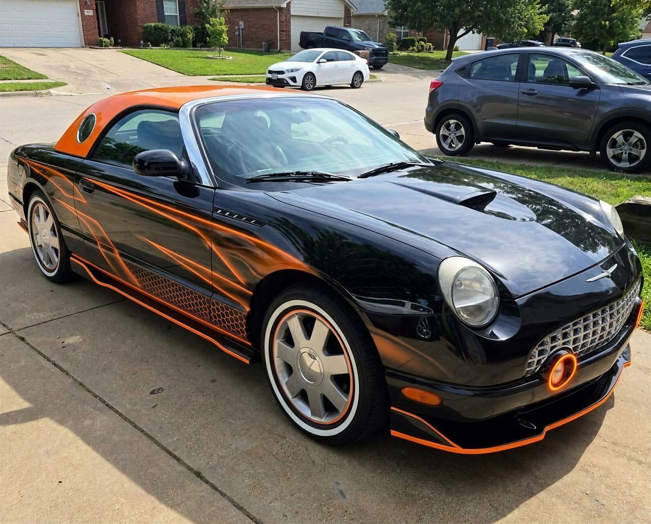 Gloss black coupe with vibrant orange accents and custom rims