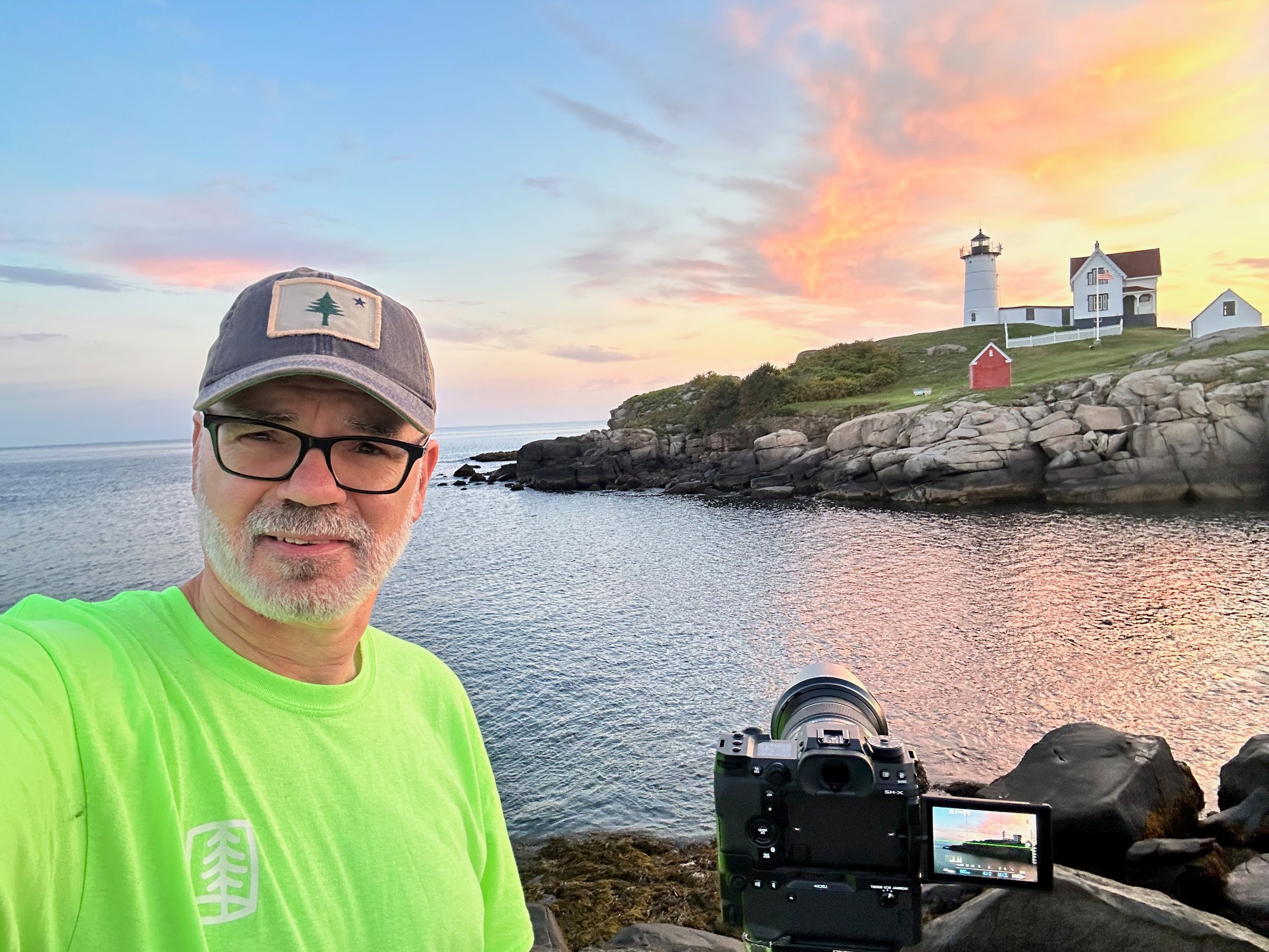 Bruce photographing at sunrise by the lighthouse