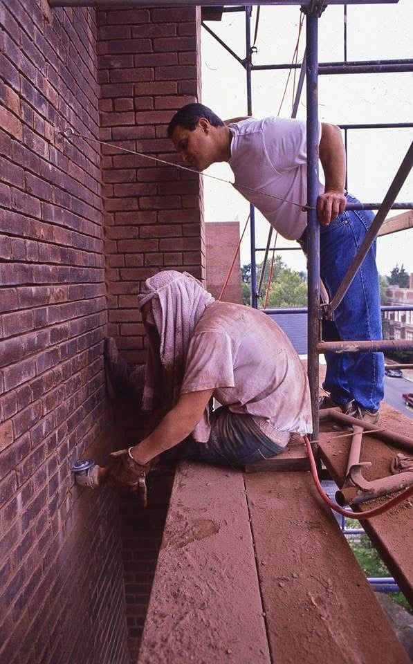 David Catucci overseeing restoration work on a brick building