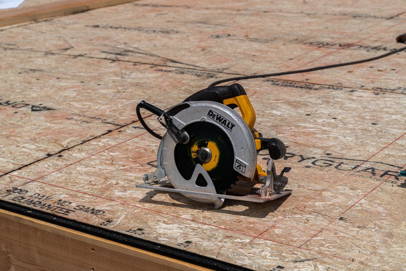 DeWalt circular saw on OSB subfloor at a construction site