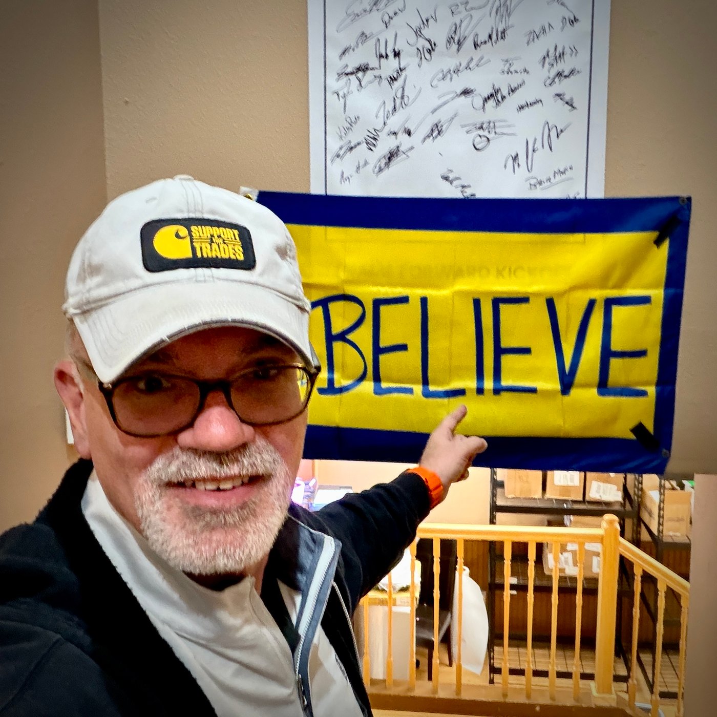 Bruce Peter Morin pointing at BELIEVE sign at UFP Site Built Lafayette, Colorado