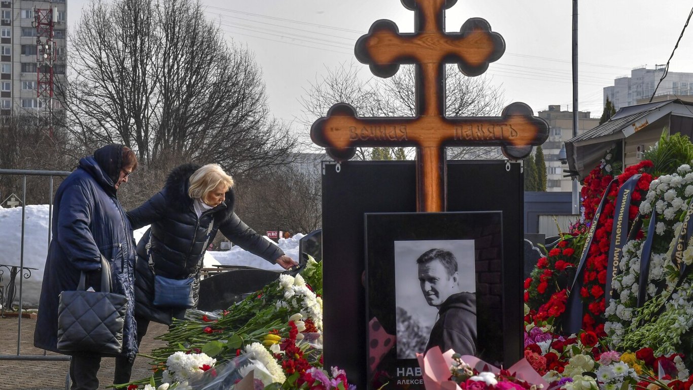 Photo of Navalnys Mother Honors His Memory with Flowers at Grave following Funeral in Moscow