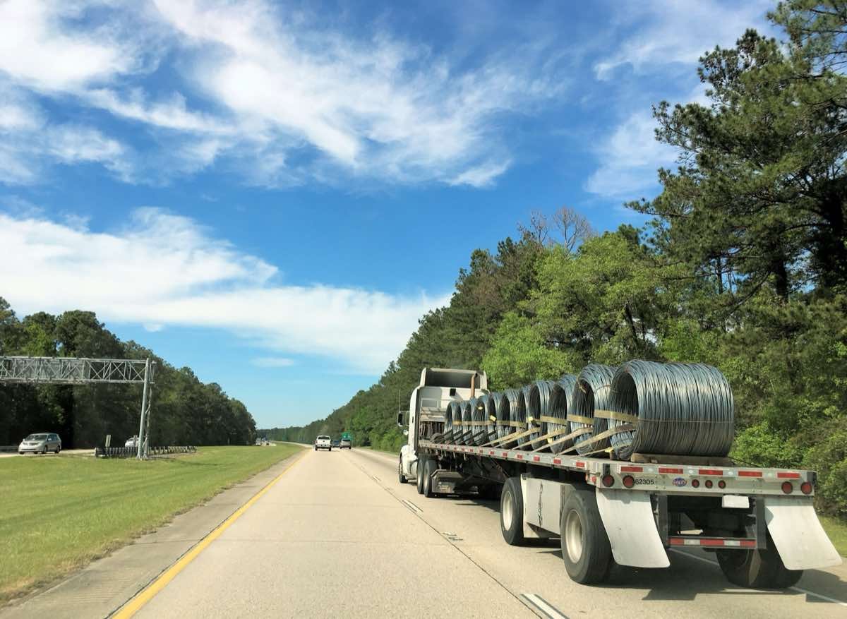 Flatbed trucking services - eighteen wheeler on interstate highway