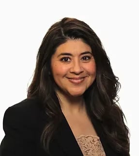 Portrait of a smiling woman against a plain white background