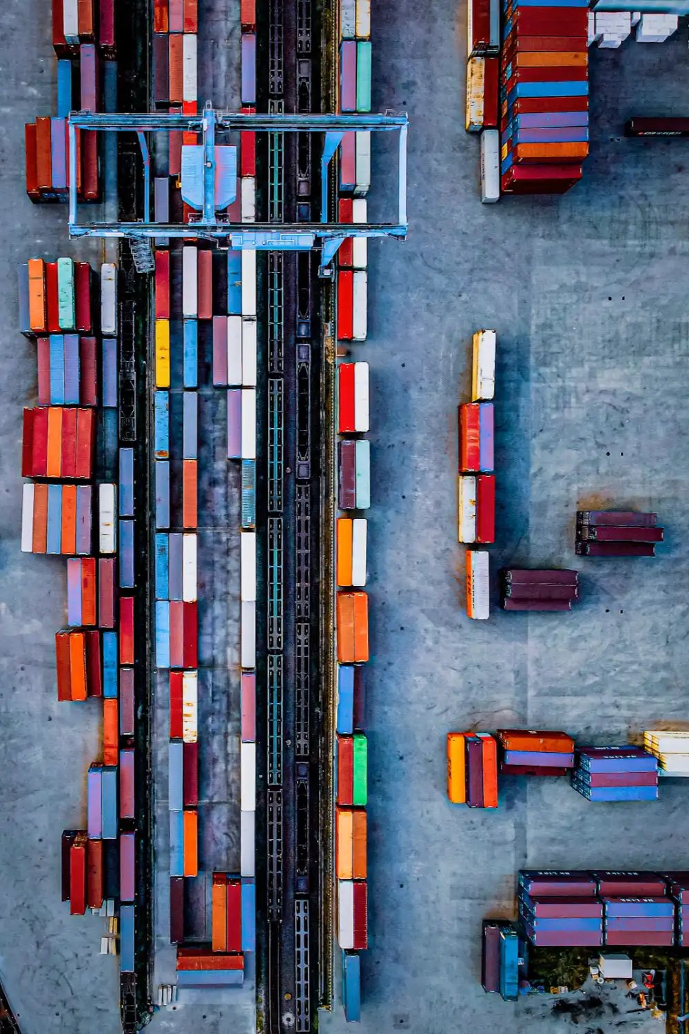 drayage1 Aerial view of an intermodal rail terminal with gantry crane and rows of containers awaiting drayage