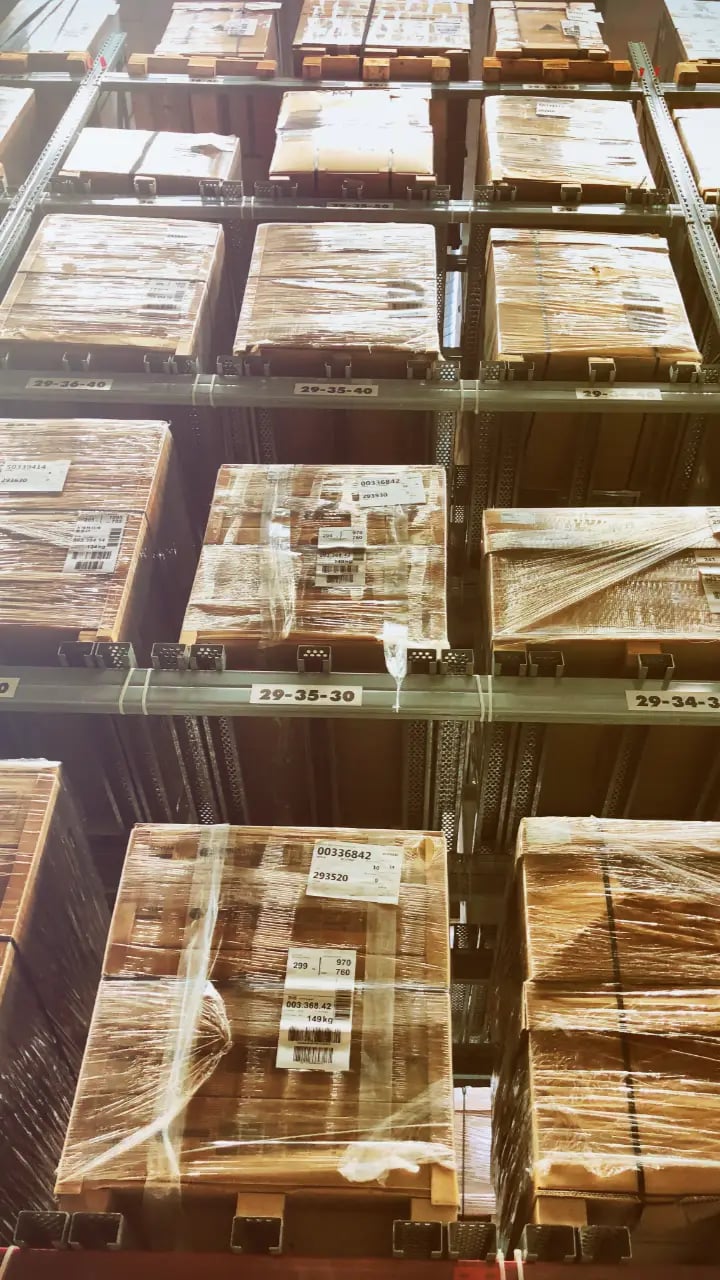 warehouse-items Tall warehouse racks filled with shrink-wrapped pallets and labels