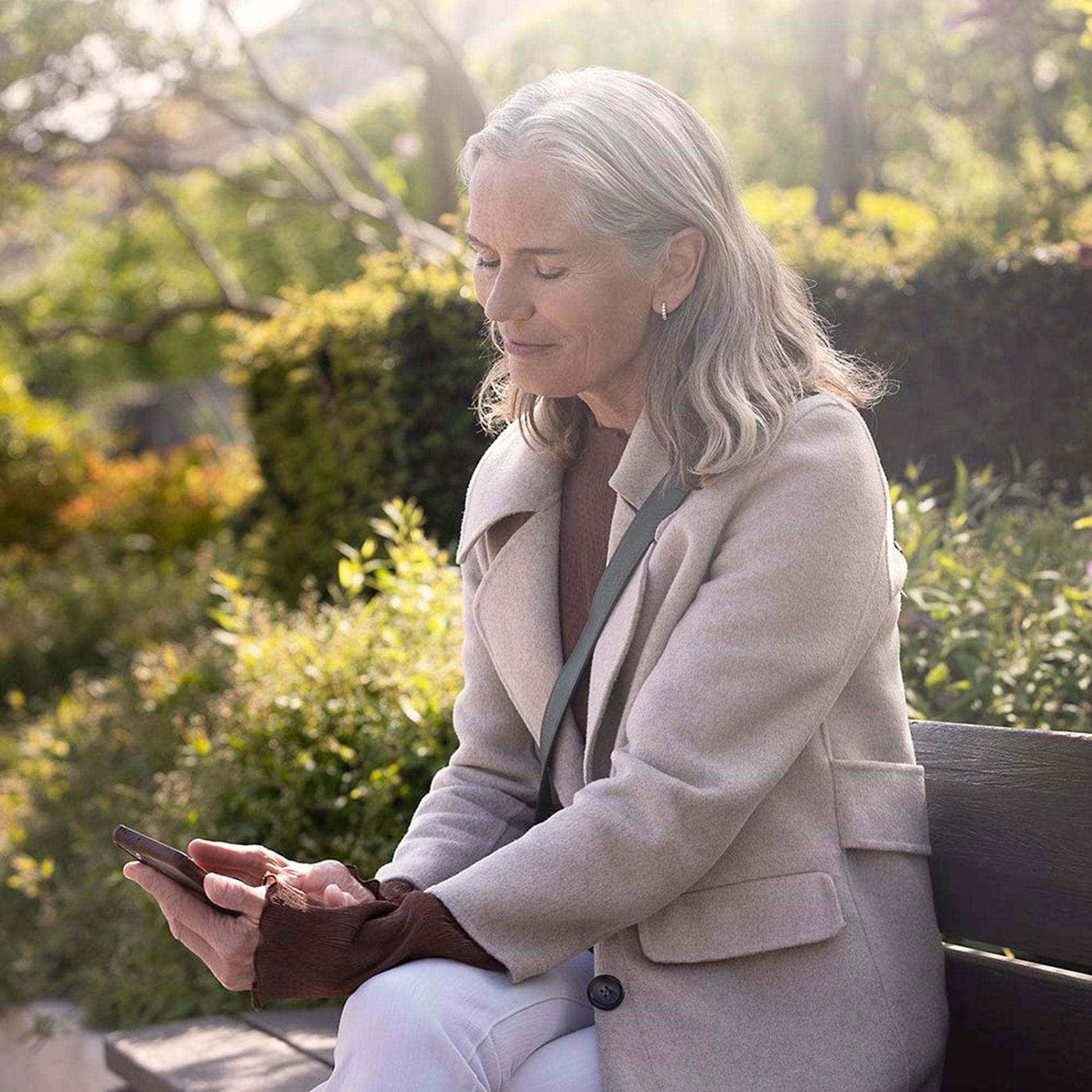  moment boost 2 woman with phone v9i2684 1000x1000 moment   the audiology place